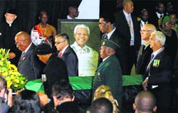 A casket of former South African President Nelson Mandela is carried during a farewell ceremony by the African National Congress at Waterkloof Air Base on the outskirts of Pretoria in South Africa on Saturday. The remains of Nelson Mandela were being transferred to his home village for burial on Sunday. AP/PTI 