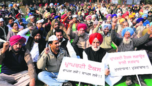 People protest against property tax at Phase IX, Mohali, on Sunday.