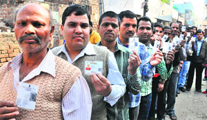 Voters queue up to cast their ballot at Dariya village in Chandigarh on Sunday. 