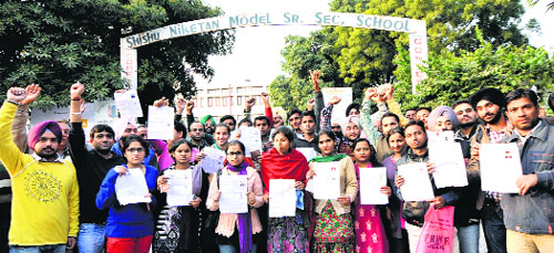 Candidates who failed to make it on time to their examination centres hold a protest outside a centre in Sector 22-D, Chandigarh. 