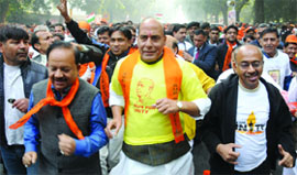 BJP president Rajnath Singh (C), Harsh Vardhan (L) with party leaders and supporters participate in the Run for Unity Marathon.