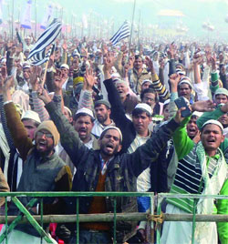 Muslim activists shout slogans as they take part in the World Peace Conference at Ramlila Ground in New Delhi on Sunday.