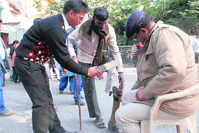 A differently-abled person asked to remove his artificial leg during checking as tight security arrangements were made at Parade Ground for the Narendra Modis rally in Dehradun on Sunday