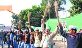 Workers of the Aam Aadmi Party form a human chain in Dehradun on Saturday to celebrate the success of their party in the recent Delhi Assembly polls
