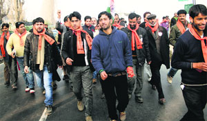 BJP activists take part in Run for Unity, organised to mark death anniversary of Sardar Vallabhbhai Patel, on the Dal Lake in Srinagar on Sunday. 