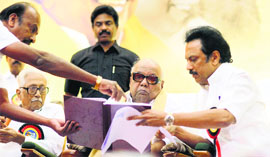 DMK chief M Karunanidhi with his son MK Stalin at the party's general council meeting at Kalainger Arangam in Chennai on Sunday.