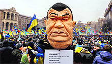 Pro-European integration protesters hold an effigy of Ukranian President Viktor Yanukovich during a rally in Independence Square in Kiev on Sunday