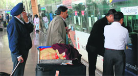 Passengers make enquiries at the Chandigarh airport on Monday.