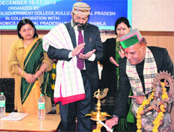 HP Planning Board vice-chairman Gangu Ram Musafir lights a lamp to inaugurate the 3rd Annual National Conference on Economics at Dev Sadan in Kullu on Monday