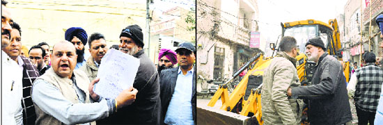 Congress councillors Balkar Singh Sandhu (sporting a black cap) and Gurpreet Singh Gogi (showing papers) trying to stop Assistant Town Planner Rajinder Sharma (fourth from right) from demolishing a building in the Ghumar Mandi area in Ludhiana
