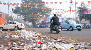 Garbage lying outside the main gate of the Khalsa College for Women in Ludhiana on Monday.
