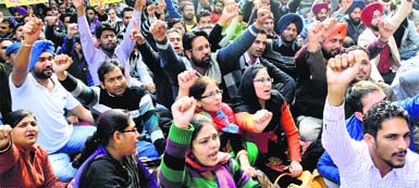 Members of the Punjab State Suvidha Karamchari Union protest in Chandigarh on Monday. Tribune photo: Manoj Mahajan