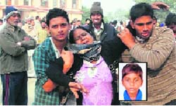 Grieving mother of the deceased (inset) boy. a Tribune photo
