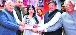 Punjabi singer Miss Pooja receives a membership certificate from state BJP chief Kamal Sharma (right) and other BJP leaders in Chandigarh on Monday. Tribune photo: S Chandan