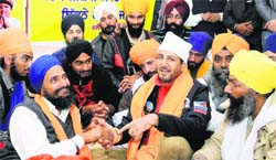 Singer Gurdas Mann with fasting leader Gurbaksh Singh Khalsa at Gurdwara Amb Sahib in Mohali on Monday. Tribune photo: Vicky Gharu