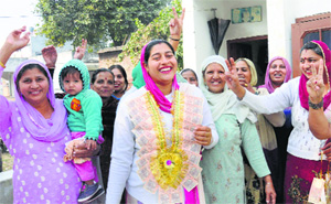 Gurvinder Kaur, who has won the election to the post of Sarpanch of Kishangarh village, with her family and supporters.