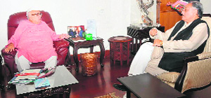 Chief Minister Vijay Bahuguna interacts with Governor Aziz Qureshi at Raj Bhavan on Tuesday. 