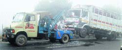 A crane is being used to remove a vehicle near Murthal police station on Tuesday. Photo: BS Malik