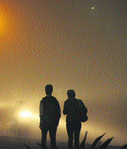 A young couple engulfed in dense fog at the busy BMC Chowk in Jalandhar on Tuesday evening.