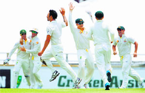 Australia are ecstatic as Johnson dismisses the last England batsman to seal the win.