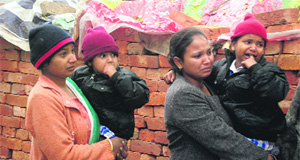 Children huddled with their mothers, as they weep at thier makeshift houses being demolished by the Amritsar Improvement Trust officials describing them as illegal in the Kabir Park area in Amritsar on Wednesday. 