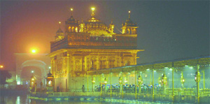 Devotees offer prayers at Golden Temple on a foggy evening in Amritsar on Wednesday.