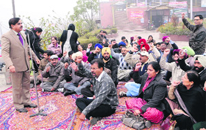 Teachers of private aided colleges hold a protest rally at Bhandari Bridge in Amritsar on Wednesday. 