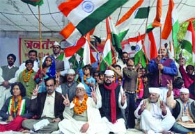 Supporters of activist Anna Hazare as both the Houses of Parliament pass the Lokpal Bill, at Jantar Mantar in New Delhi on Wednesday