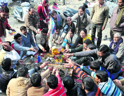 Members of the BTC Trained Teachers Organisation and suspended policemen hold a yajna in support of their demands in Dehradun on Wednesday.