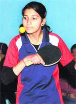 A player plays a shot during the Panchayat Table Tennis Tournament. 
