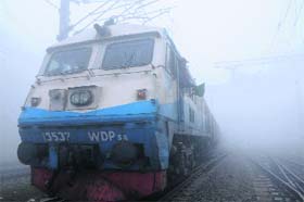 A train arrives at the Amritsar railway station on a foggy Wednesday