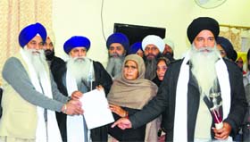 Gurbaksh Singhs family members hand over the formers Will to the Akal Takht Jathedar in Amritsar on Wednesday