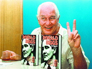This file photo shows Ronnie Biggs, known as the Great Train Robber, flashing the victory sign while presenting his autobiography Odd Man Out in Rio de Janeiro.