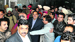People gather outside the residence of Sanjay Mehra in Katra Moti Ram area in Amritsar on Thursday