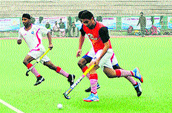 Players vie for the ball in a match during the 11th All India Maharaja Ranjeet Singh Junior Gold Cup Hockey Tournament at GNDU in Amritsar on Thursday