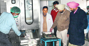 Chairman of the Verka Milk Plant, Sukhpal Singh Sidhu, and GM, Rupinder Singh Sidhu, check the packs of desi ghee in Bathinda on Thursday. 