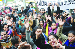 Activists under the banner of Disabled Rights Group shout slogans during a protest to introduce the Disabled Rights Bill at Parliament, outside Shastri Bhawan in New Delhi on Thursday.