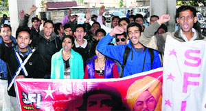 SFI members protest at the RTO office in Dehradun on Thursday . 
