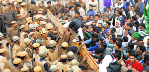 INLD workers struggle to cross the police barricade to reach the Chief Minister's residence in Rohtak on Thursday. 