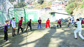 Children play cricket at the HPCA cricket academy at Lalpani in Shimla on Thursday.