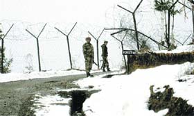 Army troops patrol after the seasons first major snowfall in Poonch on Thursday