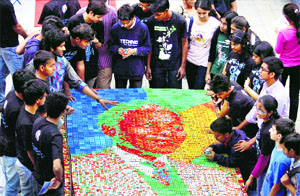 College students create a portrait of Nelson Mandela out of Rubiks cubes in Mumbai on Thursday.