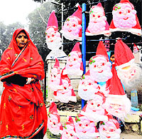 A roadside vendor sells Santa Claus masks as Christmas draws near in Amritsar