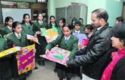 Students of St Xaviers Senior Secondary School show hand-made posters and cards to Principal Eulalio Fernandes during a competition in Bathinda on Friday. Tribune photo: Pawan Sharma