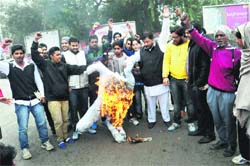 Activists of the ABVP burn an effigy of the Chandigarh police against the alleged rape by policemen in Bathinda on Friday. Tribune photo: Pawan Sharma