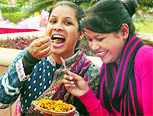 Visitiors savouring the lip smacking fare during the three-day National Street Food Festival being organised by the National Association of Street Vendors of India (NASVI), in New Delhi on Friday