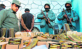 Afghan security personnel present seized ammunition with detained suspects to the media in Jalalabad on Thursday.