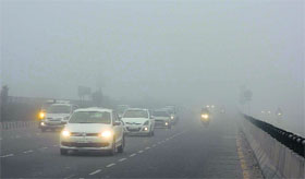 Vehicles move at a snails pace on fog-enveloped National Highway No 8 in Gurgaon on Friday morning.