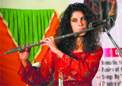 An Italian aritste plays a flute at Nankana Sahib Public School in Ludhiana.