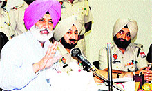 Police Commissioner Jatinder Singh Aulakh (left) and other officials show the seized heroin during a press conference